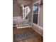 Relaxing porch with swing, patterned rug, and natural light from large windows at 4315 Bella Vista Dr, Longmont, CO 80503