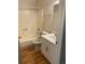 Bathroom featuring new vanity, wood look flooring, tub, and toilet at 10792 E Exposition Ave # 352, Aurora, CO 80012