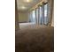 Bedroom with a large mirror sliding closet door and plush carpet at 10792 E Exposition Ave # 352, Aurora, CO 80012