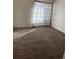 Cozy bedroom featuring plush carpeting and bright natural light streaming through decorative curtains at 10792 E Exposition Ave # 352, Aurora, CO 80012
