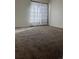 Bedroom featuring plush carpet, white walls, and simple curtains at 10792 E Exposition Ave # 352, Aurora, CO 80012