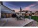 Backyard featuring a well-manicured lawn, a stained wood fence, and a concrete patio with patio seating at 11560 Kalispell St, Commerce City, CO 80022