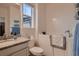Bright bathroom with a walk-in tub, granite countertop, and soft towels at 11560 Kalispell St, Commerce City, CO 80022