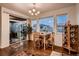 Bright dining area with a wood table set, large windows, sliding door and stylish chandelier at 11560 Kalispell St, Commerce City, CO 80022