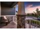 Cozy front porch with stone pillar, decorative railing, and a peaceful view of the neighborhood at 11560 Kalispell St, Commerce City, CO 80022