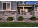 Inviting front entrance with decorative railing, stone accents, and a well-manicured lawn at 11560 Kalispell St, Commerce City, CO 80022