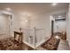 Bright hallway with a rustic table, white railing, and views of the front entrance and staircase at 11560 Kalispell St, Commerce City, CO 80022