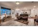 Inviting living room with hardwood floors, open to kitchen, and comfortable seating at 11560 Kalispell St, Commerce City, CO 80022