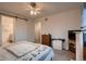 Spacious main bedroom with a sliding barn door, neutral walls, soft carpet, and ample natural light at 11560 Kalispell St, Commerce City, CO 80022