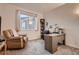 Bright home office space with a comfortable chair, lots of workspace and a window for natural lighting at 11560 Kalispell St, Commerce City, CO 80022