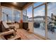 Bright sun room with several windows looking out onto the fenced backyard and patio seating area at 11560 Kalispell St, Commerce City, CO 80022
