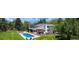 Aerial view of home showcasing lush landscaping, large swimming pool, and multiple outdoor seating areas at 5345 S Race Ct, Greenwood Village, CO 80121