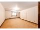 Bright basement space with a window and neutral carpet, providing a versatile area for recreation or storage at 6936 S Chapparal W Cir, Centennial, CO 80016