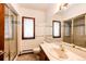 Bathroom with shower and large mirror reflecting a sink and window at 6936 S Chapparal W Cir, Centennial, CO 80016