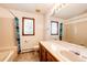 Bright bathroom featuring neutral tile, a combination tub and shower, and a large vanity at 6936 S Chapparal W Cir, Centennial, CO 80016