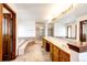 Spacious bathroom featuring double sinks, ample counter space, separate tub, and walk-in shower at 6936 S Chapparal W Cir, Centennial, CO 80016