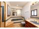 Bathroom featuring a sunken bathtub, tiled walls, and a vanity sink, offering a comfortable space at 6936 S Chapparal W Cir, Centennial, CO 80016