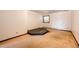 Spacious bedroom featuring carpet floors, a window for natural light, and a unique platform in the center at 6936 S Chapparal W Cir, Centennial, CO 80016