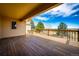 Enjoy the views from this covered wooden deck with wood railings, a perfect spot for relaxation at 6936 S Chapparal W Cir, Centennial, CO 80016