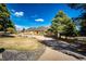 Well-maintained ranch-style home with mature trees and a circular driveway at 6936 S Chapparal W Cir, Centennial, CO 80016