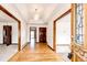Welcoming home foyer with hardwood floors and elegant light fixture at 6936 S Chapparal W Cir, Centennial, CO 80016