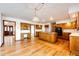 Open-concept kitchen featuring an island cooktop, a chandelier and hardwood floors at 6936 S Chapparal W Cir, Centennial, CO 80016
