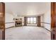 Living room featuring a stone fireplace, carpet flooring and lots of natural light at 6936 S Chapparal W Cir, Centennial, CO 80016