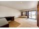 Open living room with carpet, a desk, and sliding glass doors providing access to the outdoors at 6936 S Chapparal W Cir, Centennial, CO 80016