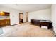 Spacious living room with a kitchen and desk area, offering an open layout with tile and carpet flooring at 6936 S Chapparal W Cir, Centennial, CO 80016