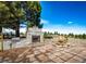 Stone outdoor fireplace and grill area on a paved patio, perfect for entertaining and enjoying the outdoors at 6936 S Chapparal W Cir, Centennial, CO 80016