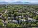 Aerial view of a peaceful residential area with tree-lined streets, showcasing many homes with solar panels at 1250 S Boyero Ct, Superior, CO 80027