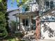 Inviting front entrance with a covered porch, brick accents, and well-kept landscaping at 1250 S Boyero Ct, Superior, CO 80027