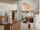 Open concept living room showcasing a stone fireplace, built-in bookshelves, and adjacent kitchen area at 1250 S Boyero Ct, Superior, CO 80027