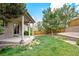 Landscaped backyard with patio, wooden fence and terraced retaining wall provides a private outdoor oasis at 3116 Black Canyon Way, Castle Rock, CO 80109