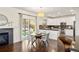 Bright kitchen and dining area with hardwood floors, a fireplace, stainless steel appliances, and backyard access at 3116 Black Canyon Way, Castle Rock, CO 80109