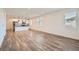 Spacious open-concept living area with modern kitchen, wood floors, and bright natural light at 2507 W 69Th Pl, Denver, CO 80221