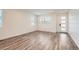 Bright, spacious living room featuring wood-look floors and large windows for natural light at 2507 W 69Th Pl, Denver, CO 80221