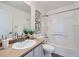 Bright bathroom features a large mirror, vanity, toilet, and shower-tub combination at 3802 Chaffee Ct, Castle Rock, CO 80109