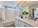 Bright bathroom with dual sinks, marble counters, and a shower and soaking tub at 3802 Chaffee Ct, Castle Rock, CO 80109