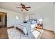 Bright bedroom with a ceiling fan, natural light, and stylish modern decor at 3802 Chaffee Ct, Castle Rock, CO 80109