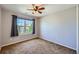 Cozy bedroom featuring neutral walls and carpet, along with a window that provides a view of the neighborhood at 3802 Chaffee Ct, Castle Rock, CO 80109