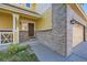 Inviting front entrance featuring brick accents, covered porch, and well-maintained landscaping at 3802 Chaffee Ct, Castle Rock, CO 80109