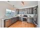 Modern kitchen with granite countertops, stainless steel appliances, and ample cabinet space at 3802 Chaffee Ct, Castle Rock, CO 80109