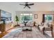Bright living room with hardwood floors, neutral decor, and large windows providing plenty of natural light at 3802 Chaffee Ct, Castle Rock, CO 80109