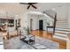 Spacious living room with hardwood floors and an open floor plan and modern stair railing at 3802 Chaffee Ct, Castle Rock, CO 80109