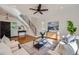 Bright living room with hardwood floors, stylish decor, a modern ceiling fan, and ample natural light at 3802 Chaffee Ct, Castle Rock, CO 80109