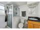Bathroom featuring a stand up shower, granite vanity, and a toilet with white tiling on the walls at 16533 E Baker Pl, Aurora, CO 80013
