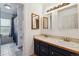 Well-lit bathroom with double sinks, a vanity with drawers, and a separate room with a bathtub and shower at 16533 E Baker Pl, Aurora, CO 80013