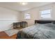 Comfortable bedroom features hardwood flooring and a dedicated workspace with desk and natural light at 16533 E Baker Pl, Aurora, CO 80013