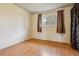 Bright, empty bedroom space featuring neutral walls, laminate flooring, and a sunlit window perfect for relaxation at 16533 E Baker Pl, Aurora, CO 80013